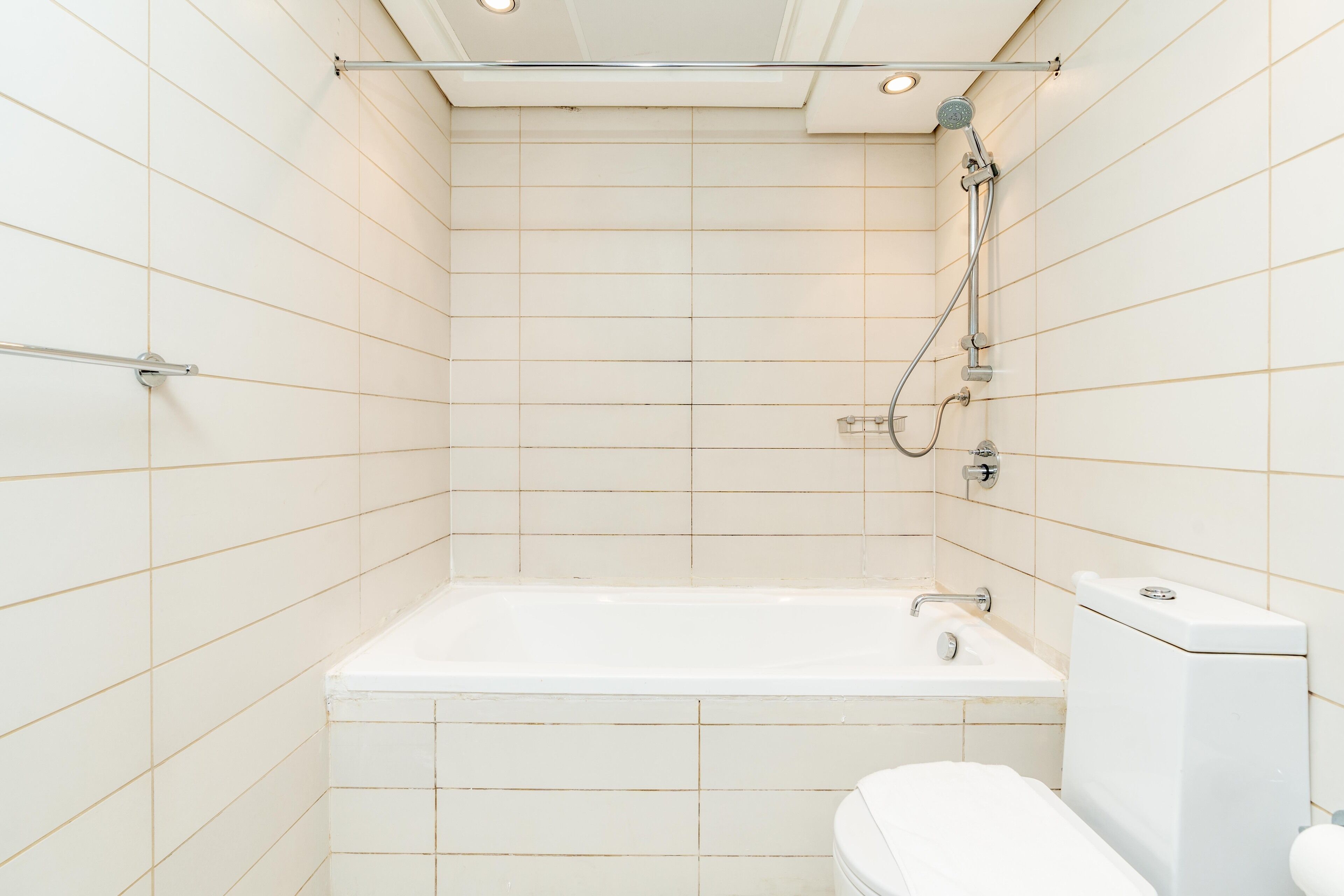 A bathroom with a bathtub, toilet, and shower.
