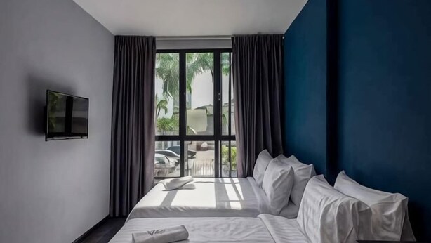 A hotel room with a bed, a TV, and a window with curtains. - Chariton Hotel Bagan (Butterworth)