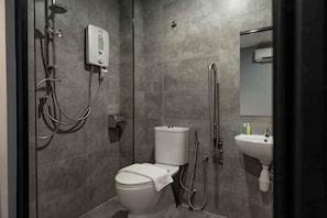 A modern bathroom with a toilet, bidet, and shower.