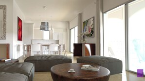 A modern living room with grey sofas, a wooden coffee table, and a dining area with white chairs. - 2-bed Designer Apartment Sleeps 4, Resort Pool (Lowlands)