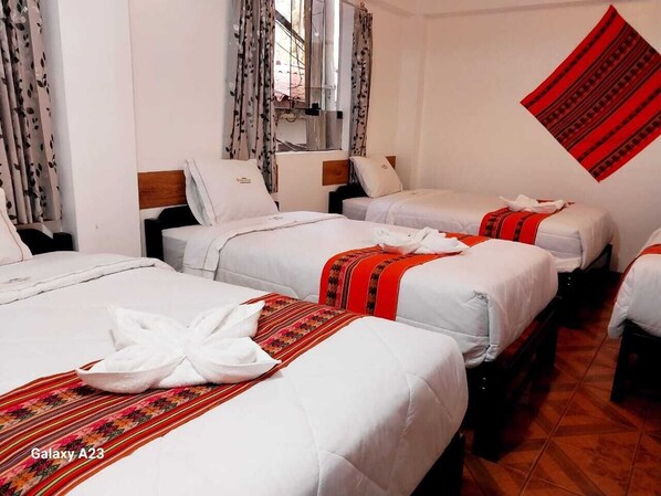 A hotel room with three beds, each with white bedding and red accents. - HOTEL VALLE DORADO (Machu Picchu)