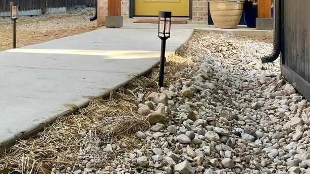A house with a yellow door, a brick exterior, and a wooden porch. - El Gato Bandito (Denton)
