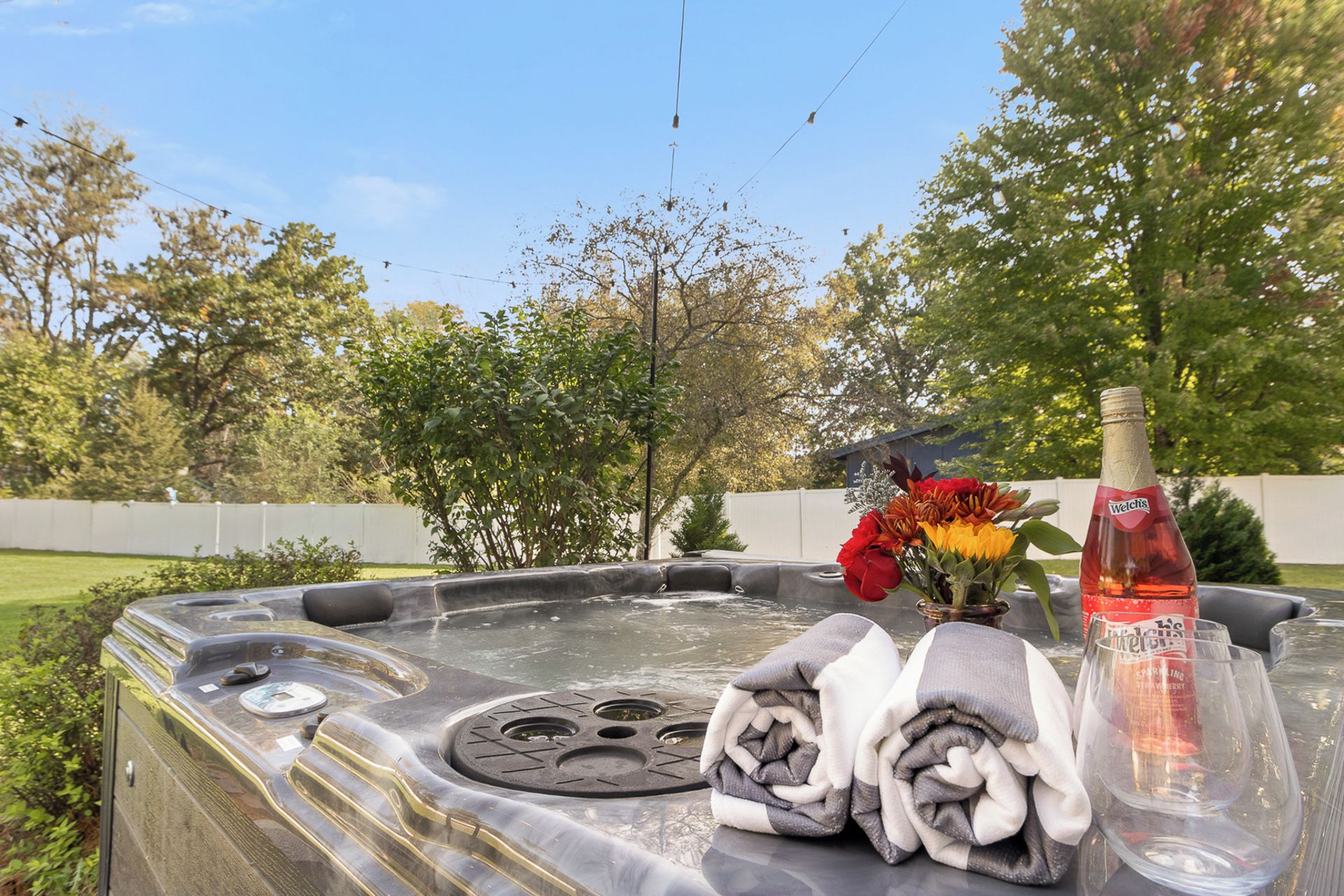 Private backyard hot tub with spa-style touches and serene garden views