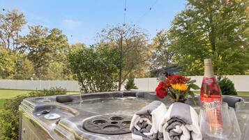 Private backyard hot tub with spa-style touches and serene garden views
