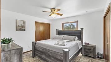 Bright, cozy bedroom with king bed, natural light, and modern rustic style