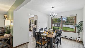 Bright dining room for 6 with backyard views and easy kitchen access