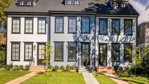 A two-story house with a front porch, a small garden, and a clear blue sky. - Gorgeous Newly Built 3BR Home in Alexandria (Alexandria)