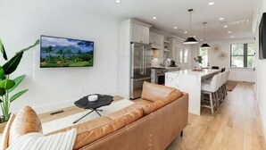 A modern kitchen with white cabinets, stainless steel appliances, and a central island. - Gorgeous Newly Built 3BR Home in Alexandria (Alexandria)
