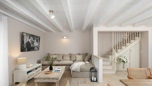 A spacious living area with a high ceiling, a sofa set, a coffee table, and a staircase. - Villa Pietrissima with Pool (Kanfanar)