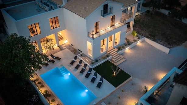 A modern two-story house with a swimming pool, outdoor seating, and a well-lit balcony. - Villa Oasi di Sogno with Pool (Biograd na Moru)