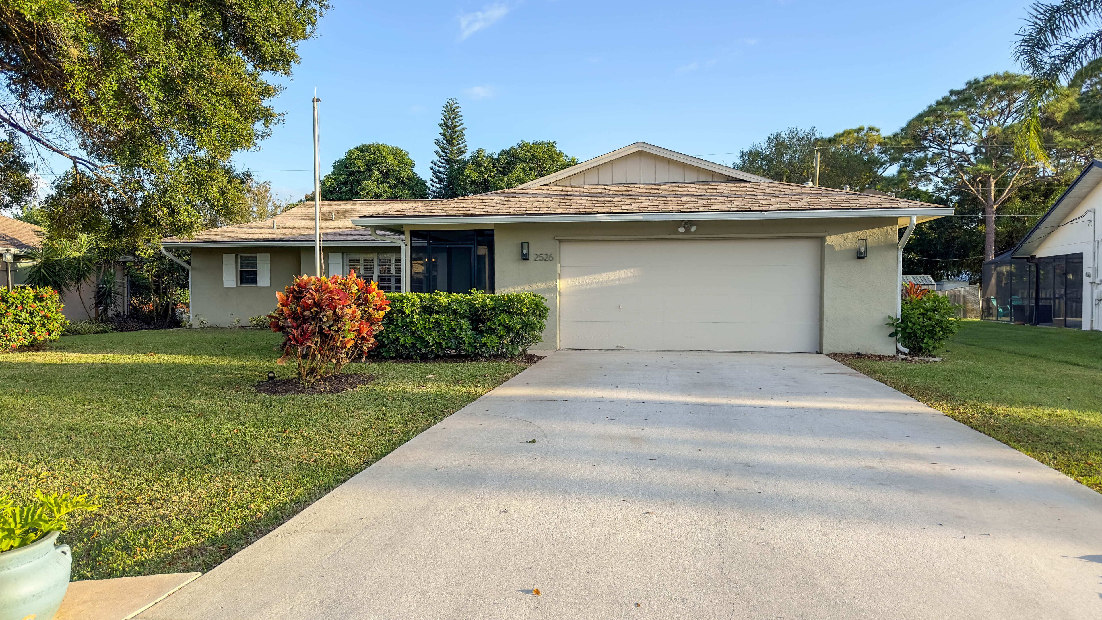 A single-story house with a garage, a front lawn, and a driveway.