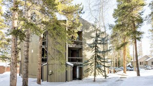 A modern building with a balcony and a snow-covered ground. - BEST VALUE three bedroom in prime Peak 8 location (Breckenridge)