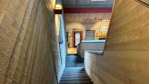 A narrow staircase with wooden walls and a skylight at the top. - Apex Mountain ~ The Powderhorn (Hedley)