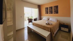 A hotel room with a bed, a bench, a nightstand, and a wall-mounted artwork. - Encantadora casa em Ponta Negra (Natal)