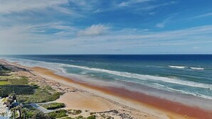 A beach with a clear sky, a sandy shore, and a view of the ocean. - Oceanside Retreat 804 by Distinctive Beach Rentals (Ormond Beach)
