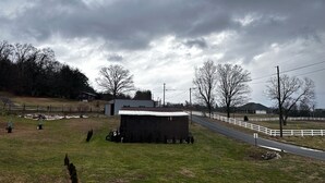 A rural landscape with a barn, a fenced area, and a road. - Camper in Dandridge. Close to the Smoky Mountains and Dollywood  (Dandridge)