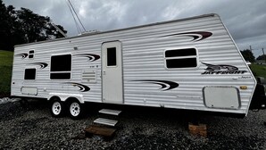 A stationary RV with a door, windows, and a logo. - Camper in Dandridge. Close to the Smoky Mountains and Dollywood  (Dandridge)