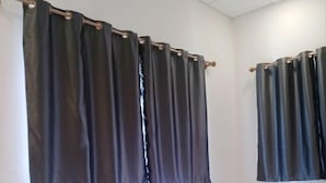 A hotel room with two beds, white bedding, and dark curtains. - PL Villa (Siem Reap)