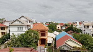 A residential area with various houses, some with balconies and different roof colors. - PL Villa (Siem Reap)