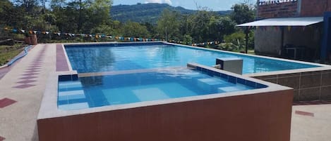 Outdoor pool, open 8:30 AM to 9:30 PM, lifeguards on site