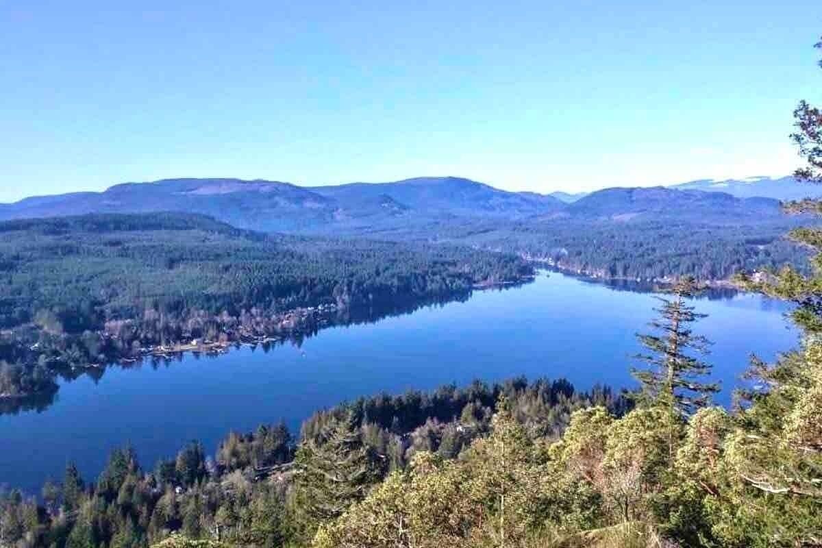 A lake surrounded by forested hills.