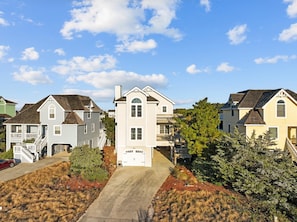 A residential area with houses featuring front porches and a central garage.