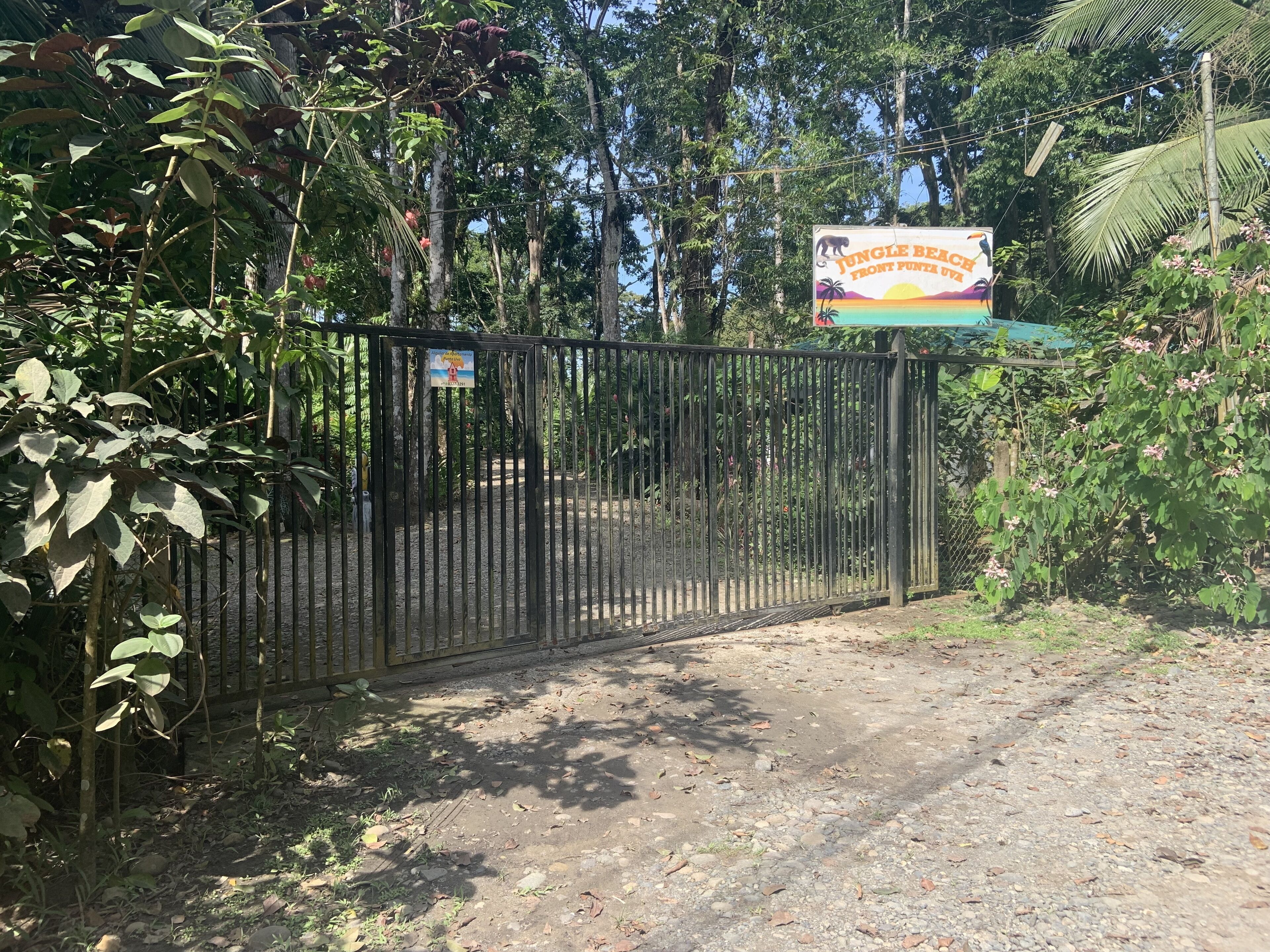 A gated entrance with a signboard.