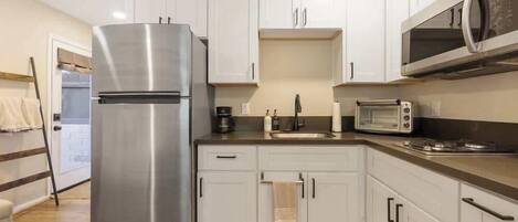 Fridge, coffee/tea maker, cookware/dishes/utensils