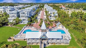 A large resort with multiple buildings, a central pool area, and surrounding greenery. - Hamilton Cottage: Steps to Beach Access + 2 Beachfront Pools (Saint Simons Island)