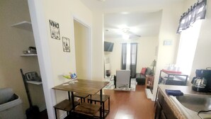 A spacious kitchen with a dining table, a coffee machine, and a refrigerator. - KASITA....5 min to river, 4min  to Christus S R hospital, state University 12min (San Marcos)
