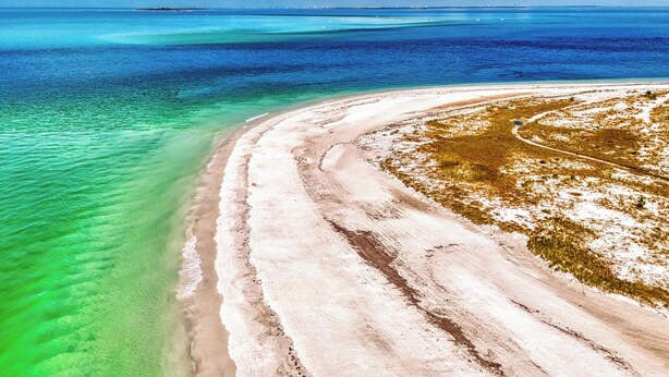 A coastal landscape with a sandy beach and clear turquoise waters. - Renovated 2bed / 1bath North End of Anna Maria, 2min walk to the beach  (Anna Maria)
