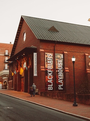 A brick building with a sign reading "BLACKFRIARS PLAYHOUSE" and "SPRING SEASON".