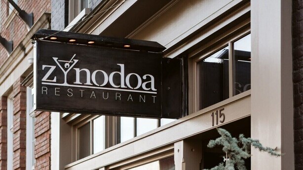 A storefront with a sign reading 'Zynodoa Restaurant' and the number '115' above the entrance. - The Shenandoah Suite: Private Balcony, Walkable (Staunton)