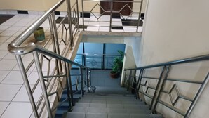 Eine Treppe mit Metallgeländern und Fliesenboden.
