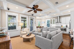 A spacious living area with a sofa, armchair, and coffee table.