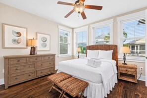 A bedroom with a bed, a dresser, two nightstands, a ceiling fan, and artwork on the wall. - Perfect Pitch - 4BR Naturewalk Home - Sleeps 10 - 6-Seat Golf Cart (Santa Rosa Beach)