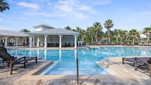 A swimming pool with lounge chairs and a covered seating area. - Perfect Pitch: Your Serene NatureWalk Haven - 6 Seater Golf Cart (Santa Rosa Beach)