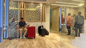 A modern hotel lobby with a seating area, a reception desk, and a staircase leading to the upper floors. - Hotel Nilakantha (Kathmandu)