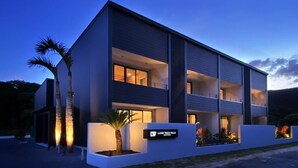 A modern multi-story hotel with a flat roof, large windows, and a sign indicating it is a luxury villa. - LUXE TECH VILLA ASHITOKU (Tatsugo)