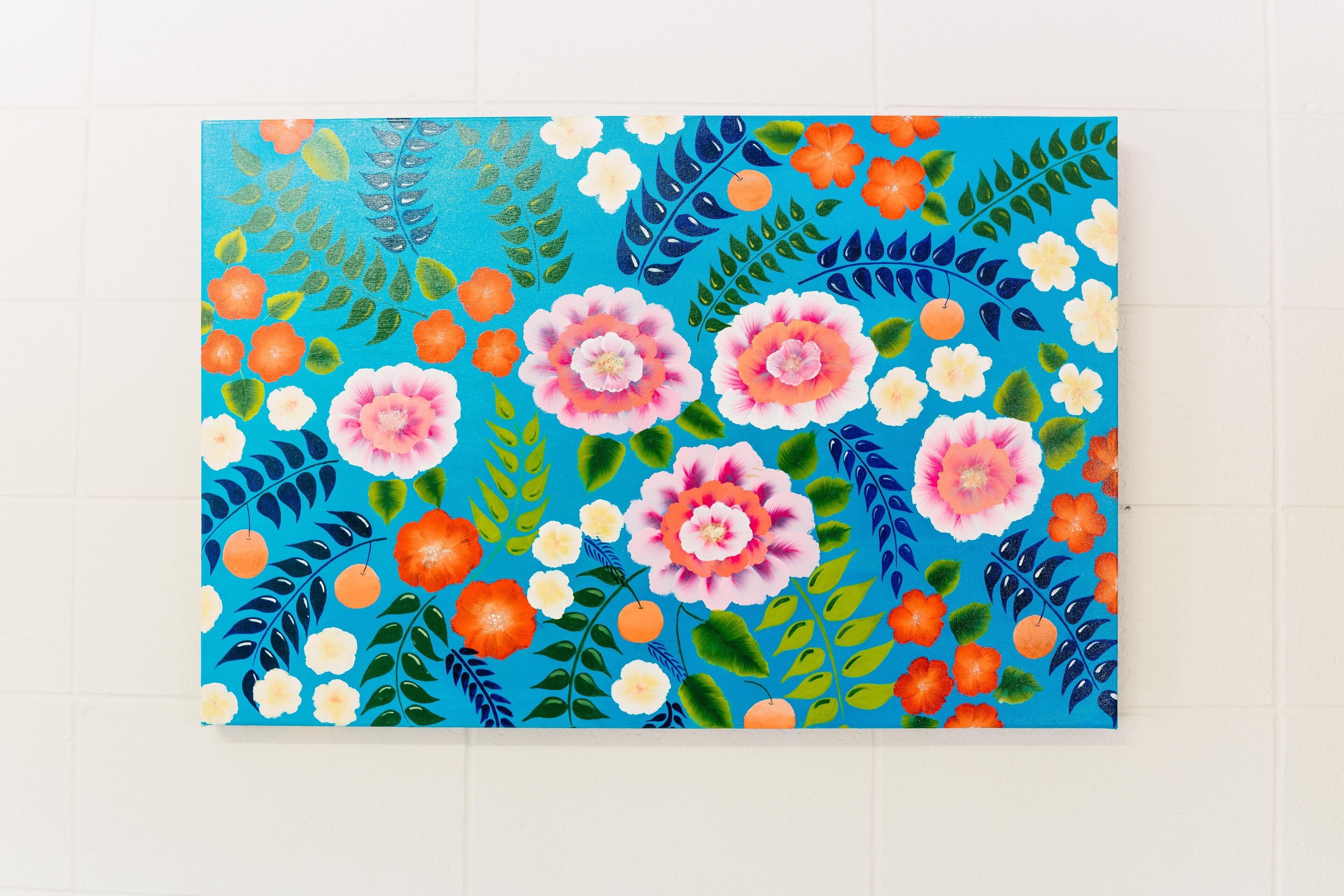 A vibrant painting with a floral and fruit pattern.