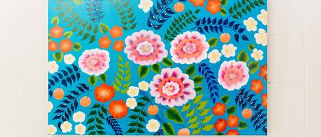 A vibrant painting with a floral and fruit pattern.