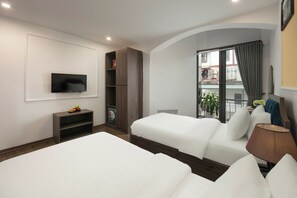 A hotel room with two beds, a TV, a bookshelf, a window with curtains, and a lamp. - Dream Boutique Hotel and Spa (Hanoi)