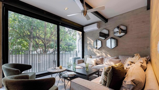 A modern living room with a sofa, armchairs, a coffee table, and a view through large windows. - Luxury Polanco Apt w/ Wine Cellar & Views (Ciudad de México)