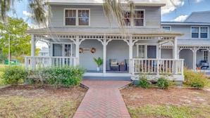A two-story house with a porch, a brick pathway leading to the entrance, and a wreath on the front door. - Waterfront Inverness Retreat w/ 3 Boat Ramps (Inverness)