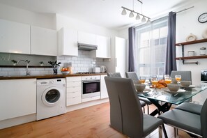 Departamento urbano | Cocina privada | Refrigerador con congelador, microondas, horno y parrilla de estufa 