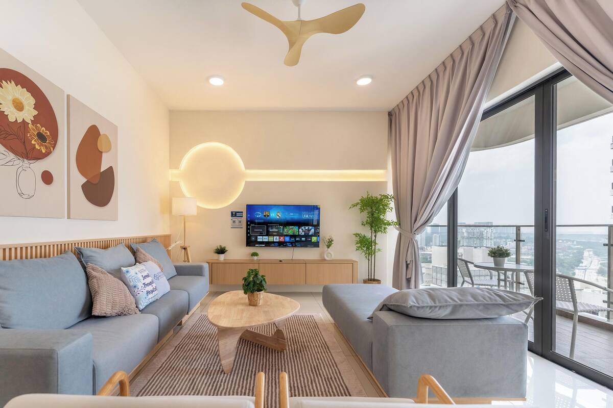 A modern living room with a sofa, coffee table, and TV.