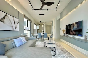 Design Condo, Pets Not Allowed, Partial Sea View | Living area | 55-inch Smart TV with cable channels, Netflix, streaming services