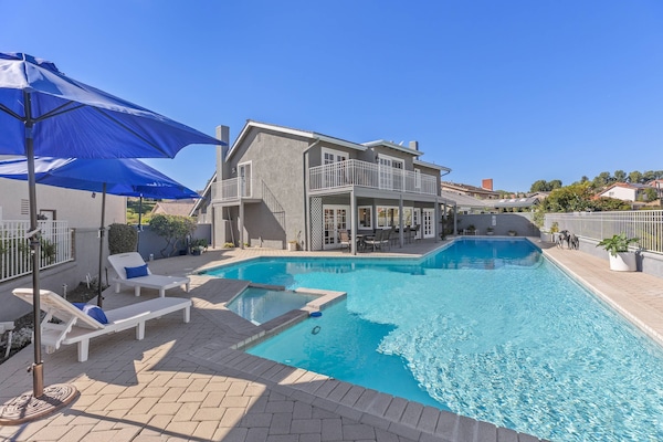 75' pool and jacuzzi with lounge and table seating