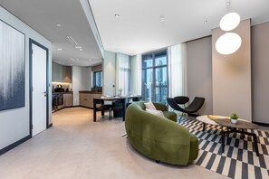 Deluxe Apartment | Living area | 65-inch Smart TV with cable channels, Netflix, streaming services - Waves - Serene Waterfront Elegance: 2BR Haven in Business Bay (Dubai)