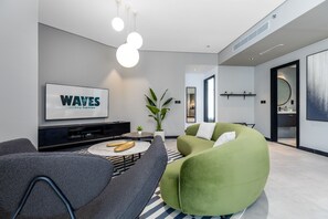 Deluxe Apartment | Living area | 65-inch Smart TV with cable channels, Netflix, streaming services - Waves - Serene Waterfront Elegance: 2BR Haven in Business Bay (Dubai)
